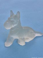 Side view of one frosted glass Scottie dog figurine