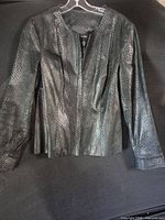 Full front view of black faux snakeskin Alfani jacket hanging