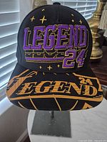 Front view of cap showing Legend 24 embroidery and brim print