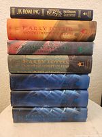 Front view of seven stacked hardcovers showing spines and titles