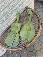 Violin and mandolin wall plaques on wicker table