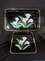 Full view of both trays nested, showing size difference and floral motif