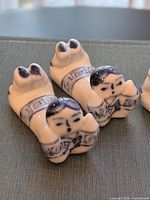 Two chopstick rests close-up showing painted detail and shape