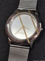 Close view of watch face showing Skagen Denmark branding, silver dial, gold-tone hands and markers