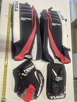 Full set laid out with measuring tape showing leg pad length