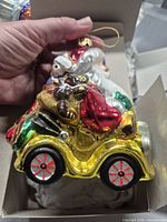 Left side view of Santa glass ornament in box