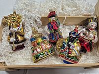 Overview of all five ornaments in wooden crate