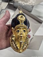 Front view of Tutankhamun glass ornament in hand