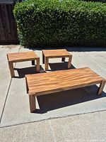 Coffee table and two end tables outdoors