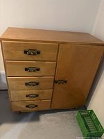 Front view showing five drawers and cubby door