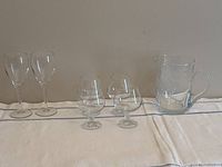 Group view showing two wine glasses, four brandy glasses, and jug