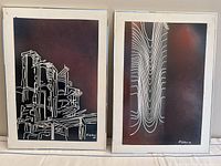 Pair of maroon-background prints showing cityscape and wave motifs