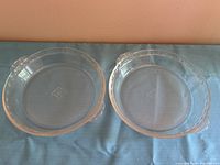 Both clear Pyrex pie plates side by side