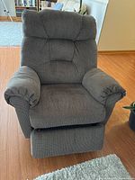 Front view of brown tweed manual recliner with footrest closed