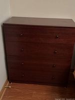 Front view showing four drawers and knobs