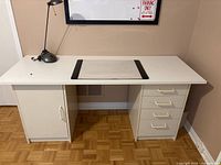Front view of white desk showing cabinet and drawers
