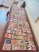 Wide view of entire assortment of Topps baseball cards spread on table