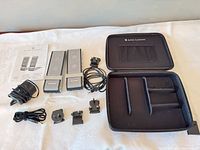 Complete lot showing speakers, case, cables, adapters and manual