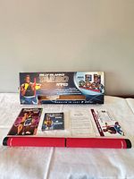 Complete Tae Bo Amped set with bar, DVDs, booklet, paperwork and box displayed on table