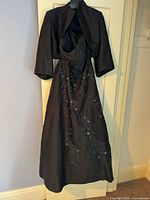 Gown on hanger with bolero showing general design and color