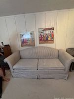 Front view of blue & white pinstripe sleeper sofa