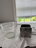 Glass and metal planters side by side