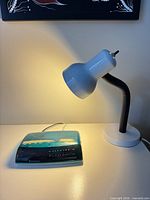 Alarm clock and desk lamp together on table