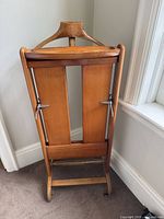 Front view of folded wooden valet stand