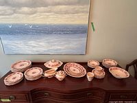 Entire dinnerware set displayed on sideboard