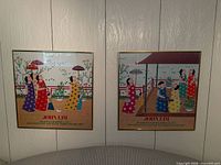 Both framed John Lim prints on wall