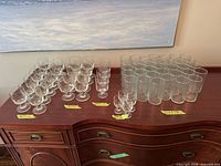 All glassware groups on cabinet: stemmed goblets, medium stemmed, assorted stemmed, cordial glasses, tall tumblers