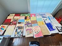 Entire lot laid out on table showing quantity and variety of sheet music pieces