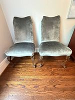 Front view of both gray upholstered carved wood side chairs