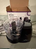 Rival mini chopper unboxed, clear bowl on black base, power cord visible