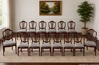 Full set of fourteen matching mahogany finish dining chairs arranged in two rows