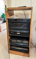 Wood rack containing amplifier, tuner, cassette deck and CD changer