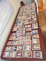 Entire spread of loose Topps baseball cards laid out on table