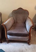 Front view of upholstered armchair showing overall design, color and condition