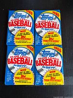 Front view of four sealed 1986 Topps Baseball wax packs