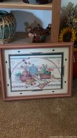 Full view of framed print standing on carpet