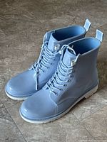 oblique front view of both boots showing color, laces, and outsole