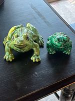 front view of both ceramic frog figurines