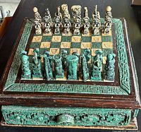 Oblique view of board showing green stone border, full set of pieces, and drawer front