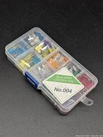 Closed organizer case showing assorted coloured fuses and certificate label