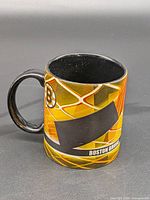 Front view of the Boston Bruins ceramic mug showing team graphics