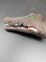 Side view of crocodile hand puppet showing texture, eyes, teeth