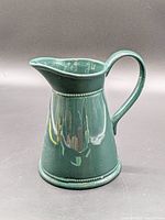 Full view of green glazed ceramic pitcher