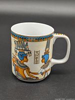 Mug left side view showing Egyptian figures and hieroglyphics