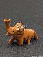front view showing carved elephant shape and keyring attachment