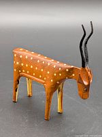 Left-front view showing body shape, paint details, horns